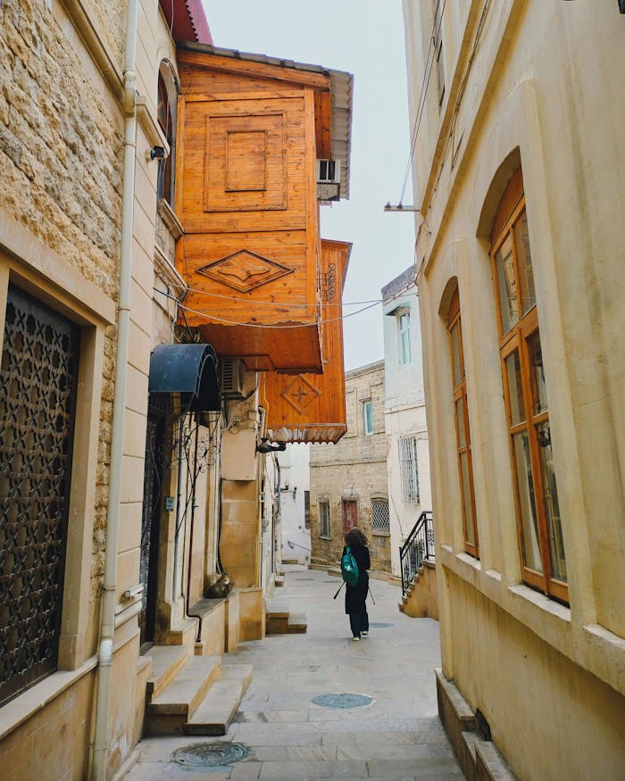 A solitary figure walks down a narrow alley in Baku's historic Old City.
