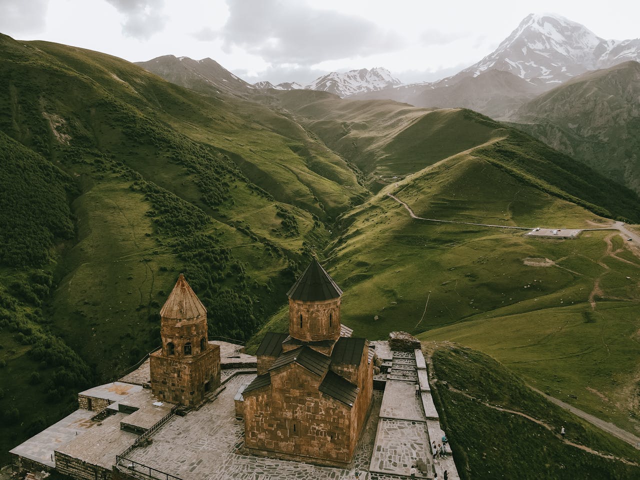 Aerial view of Gergeti Trinity Church set in the stunning Caucasus Mountains of Georgia.